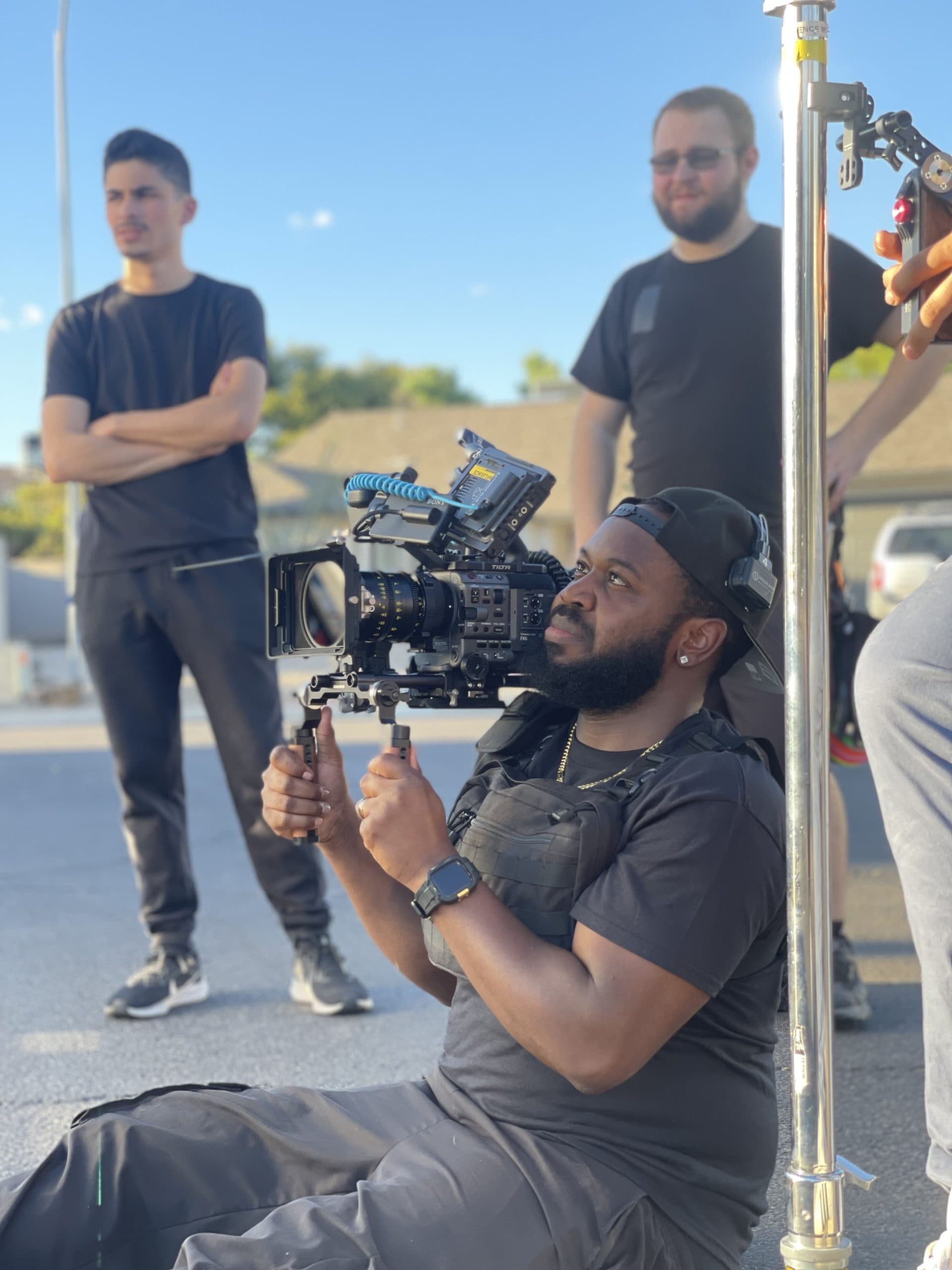 Influence Studios crew filming on location with a gimbal rig at golden hour