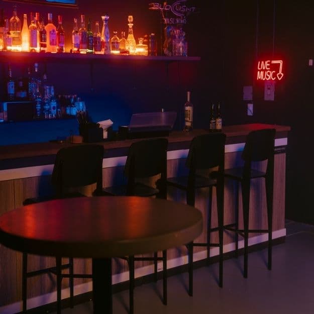 Neon-lit standing bar set at Influence Studios in Glendale, the studio's own hospitality set