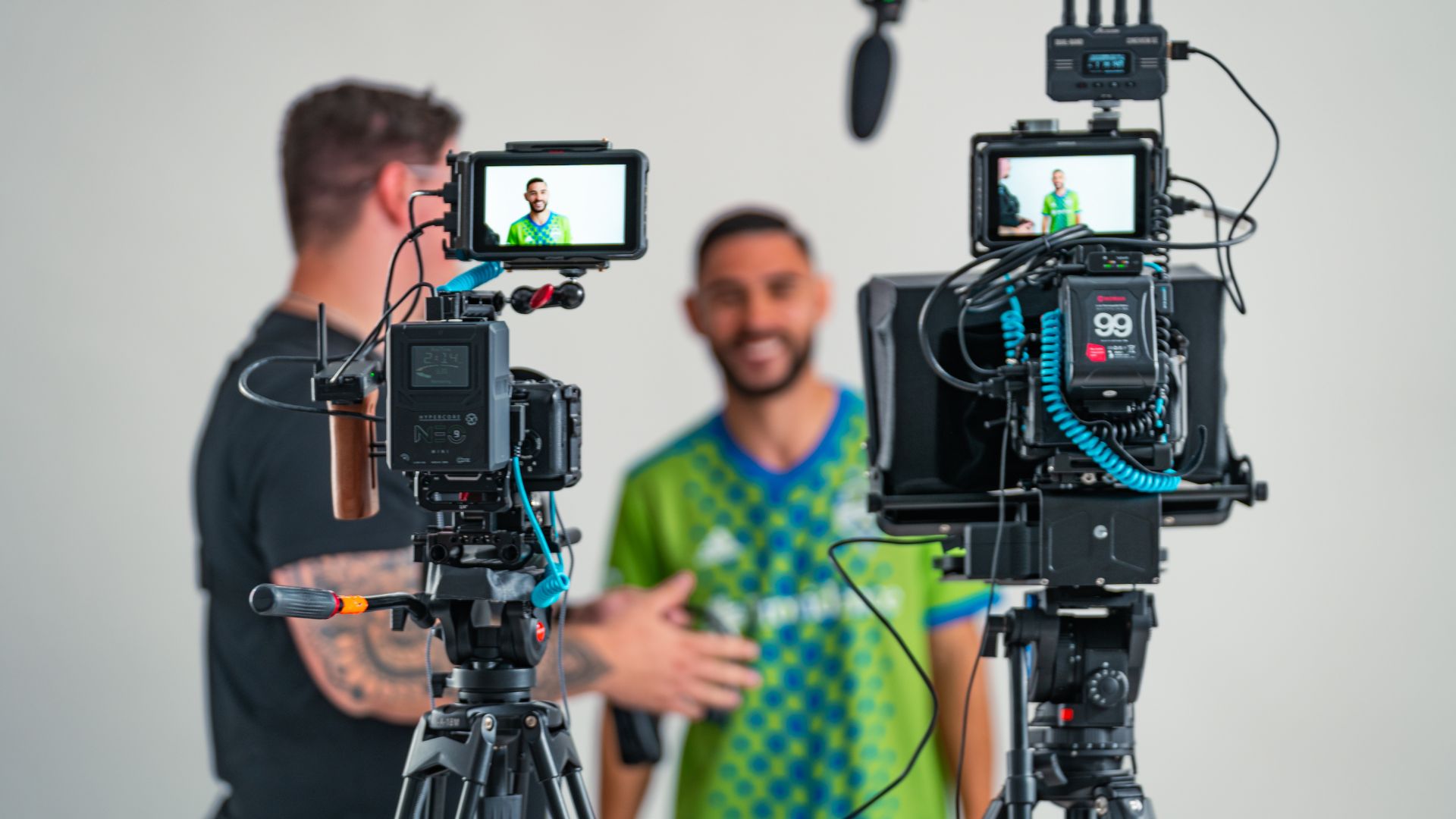 Two-camera interview setup with an athlete in a Seattle Sounders jersey